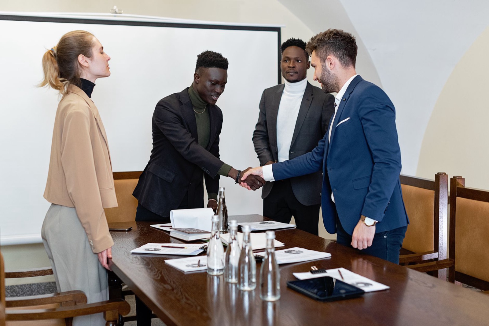 A handshake across a meeting table